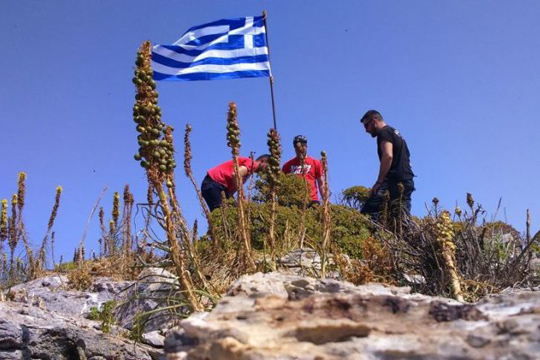 Каменос со критики до Грците кои поставија грчкото знаме на ненаселен остров